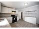 Modern kitchen with white cabinets, granite countertops and black appliances at 2574 Orchard Rd, Smyrna, SC 29743