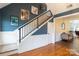 Modern staircase with a metal railing and hardwood floors at 114 Market St, Rockwell, NC 28138