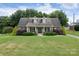 Brick home with a covered front porch and landscaping at 114 Market St, Rockwell, NC 28138
