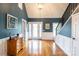 Two-story entryway with hardwood floors, a chandelier, and white wainscoting at 114 Market St, Rockwell, NC 28138