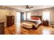 Main bedroom with hardwood floors, a large bed, and access to a private bathroom at 114 Market St, Rockwell, NC 28138