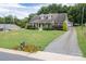 Well-maintained house with a gravel driveway and lush green lawn at 114 Market St, Rockwell, NC 28138