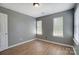 Bright bedroom with three windows and wood-look floors at 12700 Cedar Crossings Dr, Charlotte, NC 28273