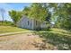Charming gray house with a front porch and landscaped yard at 1021 Wall St, Statesville, NC 28677