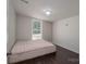 Simple bedroom with window and dark brown flooring at 1021 Wall St, Statesville, NC 28677