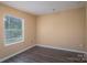 Simple bedroom with window and dark brown flooring at 1021 Wall St, Statesville, NC 28677
