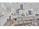 Modern kitchen island with seating and white cabinets at 6639 Ronda Ave, Charlotte, NC 28211