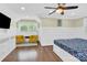 Spacious bedroom with hardwood floors, two armchairs, and a TV at 6639 Ronda Ave, Charlotte, NC 28211