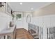 Elegant stairwell with a white railing and hardwood floors at 6639 Ronda Ave, Charlotte, NC 28211