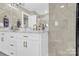 Elegant bathroom with double vanity, marble countertops, and gold fixtures at 6639 Ronda Ave, Charlotte, NC 28211