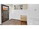 Bright entryway with dark hardwood floors and built-in storage at 6639 Ronda Ave, Charlotte, NC 28211