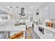 Renovated kitchen featuring a large island, white cabinets, and quartz countertops at 6639 Ronda Ave, Charlotte, NC 28211