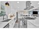 Modern kitchen with white cabinets, large island, and high-end appliances at 6639 Ronda Ave, Charlotte, NC 28211