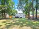 Large backyard with lush lawn and mature trees at 6639 Ronda Ave, Charlotte, NC 28211