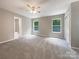 Spacious bedroom with carpet flooring and two large windows at 48 Magnolia St, York, SC 29745