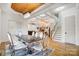 Elegant dining room with modern table and chairs, hardwood floors, and view of staircase at 205 W Phifer St, Monroe, NC 28110