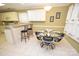 Breakfast nook with a glass-top table and four chairs, adjacent to the kitchen at 6929 Plough Dr, Charlotte, NC 28227
