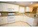 Kitchen boasts granite countertops, white cabinets, and stainless steel appliances at 6929 Plough Dr, Charlotte, NC 28227
