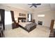 Spacious main bedroom with a ceiling fan, fireplace, and ample natural light at 6929 Plough Dr, Charlotte, NC 28227