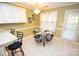 Breakfast nook with a glass-top table and four chairs, adjacent to the kitchen at 6929 Plough Dr, Charlotte, NC 28227