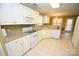 Kitchen boasts granite countertops, white cabinets, and stainless steel appliances at 6929 Plough Dr, Charlotte, NC 28227