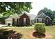 Brick and siding ranch home with landscaped yard at 6929 Plough Dr, Charlotte, NC 28227