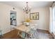 Bright dining area with a rustic table and chandelier, open to the kitchen at 9037 Castlebay Dr, Charlotte, NC 28277