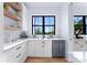 White kitchen with stainless steel appliances and a corner sink at 18304 Rosapenny Rd, Charlotte, NC 28278