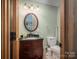 Basement bathroom with dark vanity, updated fixtures and a pedestal sink at 213 Press Sweezy Rd, Kings Mountain, NC 28086