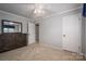 Bedroom with dark dresser, ceiling fan and neutral colored walls at 213 Press Sweezy Rd, Kings Mountain, NC 28086