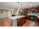 Island kitchen with granite countertops, stainless steel appliances, and hardwood floors at 213 Press Sweezy Rd, Kings Mountain, NC 28086