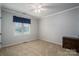 Bedroom with neutral walls, carpet, and window with blue curtains at 213 Press Sweezy Rd, Kings Mountain, NC 28086