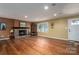 Spacious living room featuring hardwood floors, a stone fireplace, and large windows at 213 Press Sweezy Rd, Kings Mountain, NC 28086