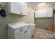Bright laundry room with white cabinets and marble countertop at 213 Press Sweezy Rd, Kings Mountain, NC 28086