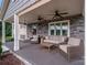 Inviting front porch with wicker furniture, ceiling fans, and stone details at 213 Press Sweezy Rd, Kings Mountain, NC 28086