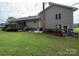 Rear view of house showcasing stone accents and landscaping at 213 Press Sweezy Rd, Kings Mountain, NC 28086
