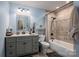Updated bathroom with gray vanity, tile shower and bathtub at 213 Press Sweezy Rd, Kings Mountain, NC 28086