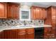 Well-appointed kitchen with double sink, granite countertops, and wood cabinets at 213 Press Sweezy Rd, Kings Mountain, NC 28086