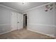 Spacious bedroom with neutral walls, carpet, and double doors to closet at 213 Press Sweezy Rd, Kings Mountain, NC 28086