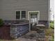Exterior basement entrance with stonework and storm door at 213 Press Sweezy Rd, Kings Mountain, NC 28086