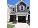 Two-story townhome with gray and beige siding and attached garage at 779 Earhart Nw St, Concord, NC 28027