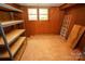 Unfinished basement room with wood paneling and window at 44097 Nc 740 Hwy, New London, NC 28127