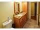 Bathroom boasts granite countertop, wood cabinets, and tiled floor at 44097 Nc 740 Hwy, New London, NC 28127