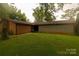 Brick house with partial stone exterior and a grassy yard at 44097 Nc 740 Hwy, New London, NC 28127