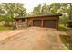 Two-car garage with brown doors and a spacious driveway at 44097 Nc 740 Hwy, New London, NC 28127