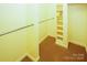 Bright walk-in closet with shelving and hanging rods at 44097 Nc 740 Hwy, New London, NC 28127
