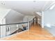 Long hallway with hardwood floors and a view into a living area with a fireplace at 3245 Jackson Rd, Mooresville, NC 28115