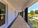 Long covered porch with tile floor and view of the landscape at 3245 Jackson Rd, Mooresville, NC 28115