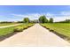 Long driveway leading to a charming house with manicured landscaping at 3245 Jackson Rd, Mooresville, NC 28115