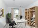 Bright home office features a large desk, built-in shelving, and comfortable seating at 3245 Jackson Rd, Mooresville, NC 28115